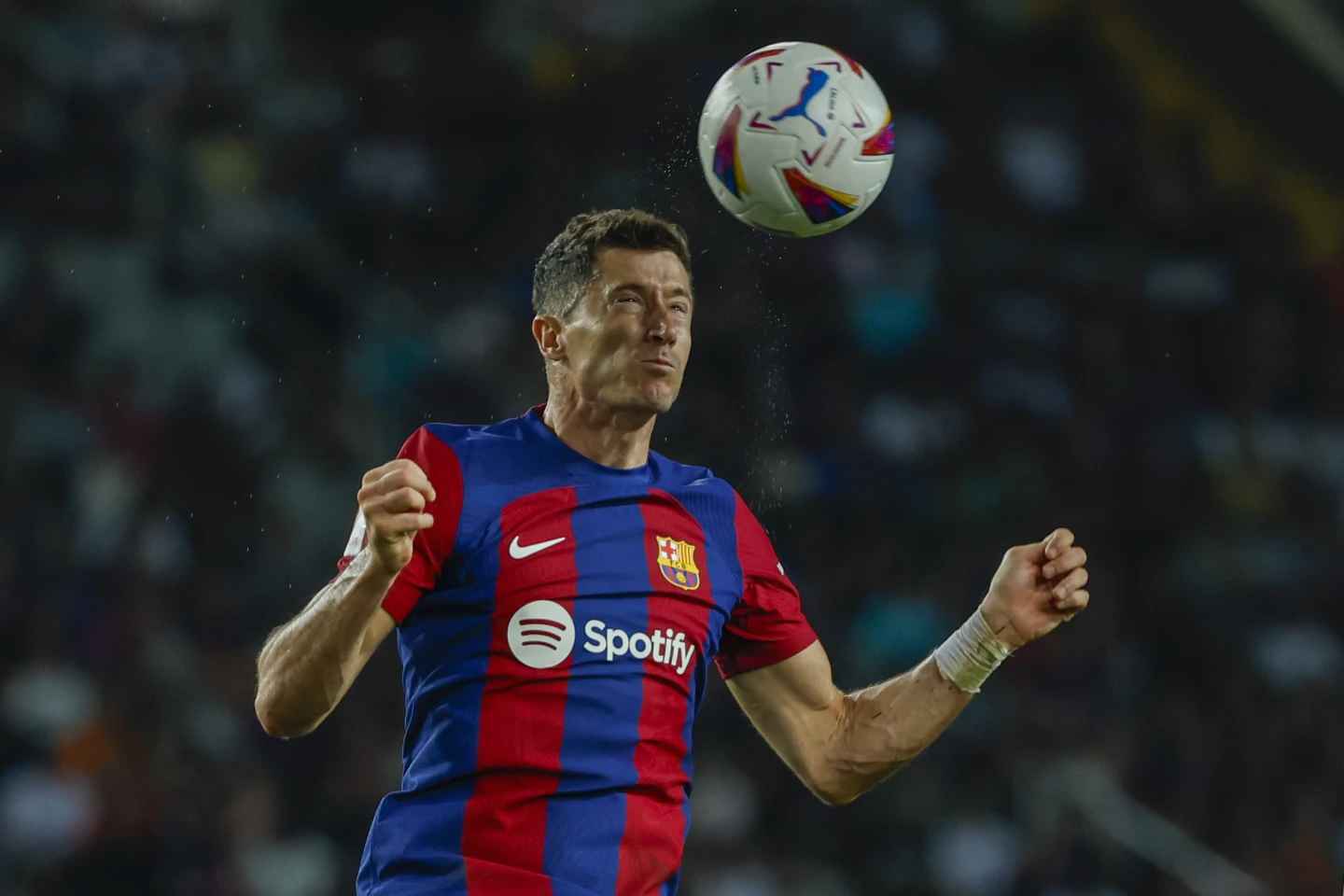 Barcelona's Robert Lewandowski heads the ball during a Spanish La Liga soccer match between Barcelona and Sevilla on Friday, September 29, 2023, at the Olympic Stadium of Montjuic in Barcelona, Spain. (Photo courtesy of AP/Joan Monfort)