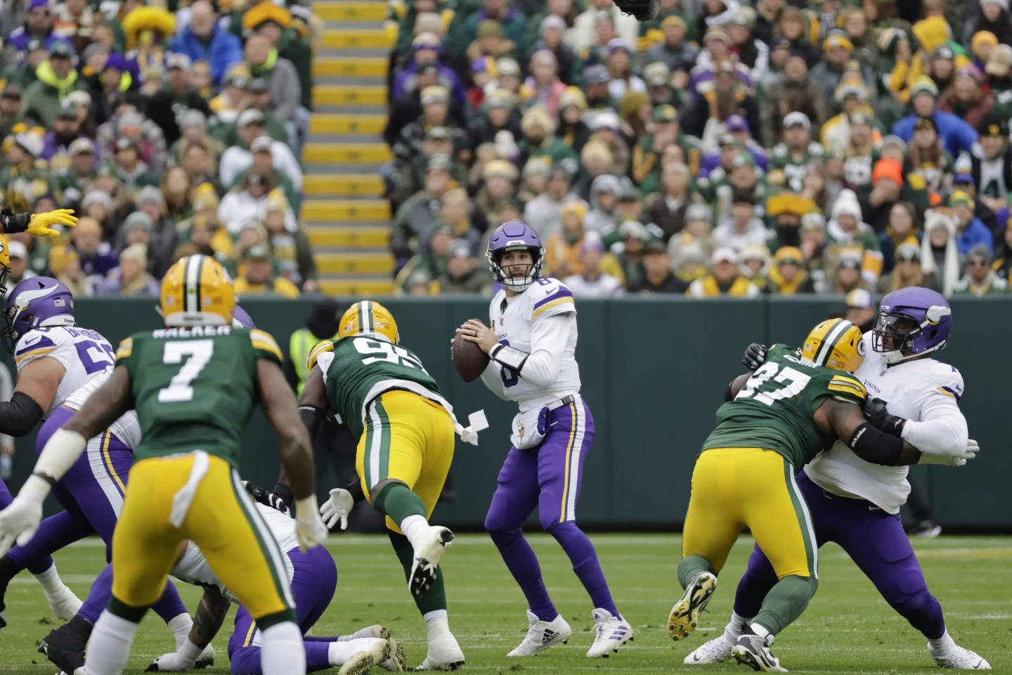 Kirk Cousins (8) of the Minnesota Vikings, center, looks to pass during the first half of an NFL football game against the Green Bay Packers on Sunday, Oct. 29, 2023, in Green Bay, Wis. (Photo by Mike Roemer