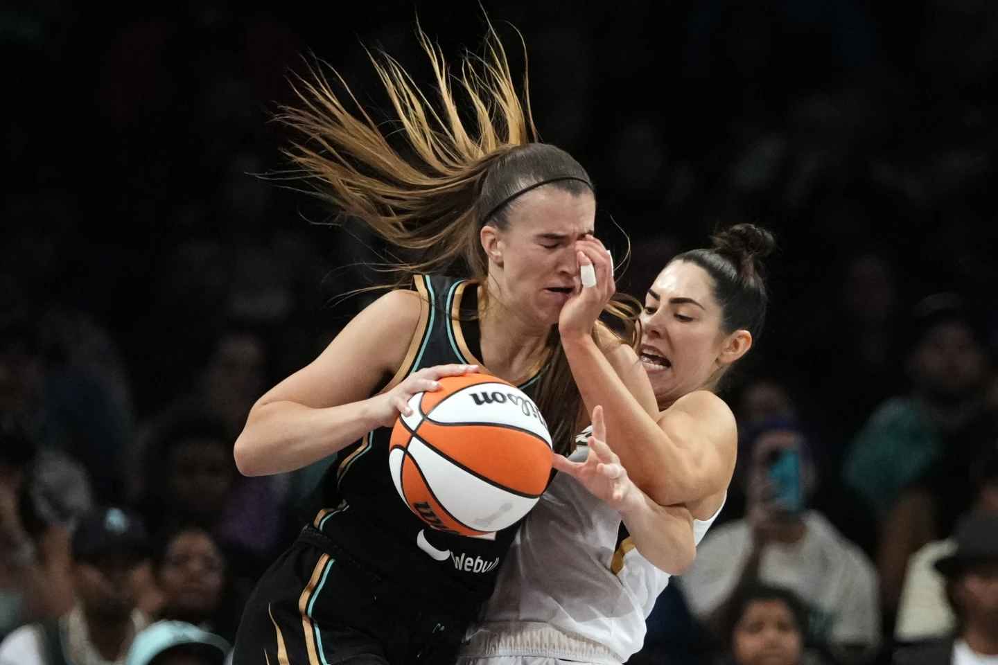 Kelsey Plum of the Las Vegas Aces, right, guards Sabrina Ionescu of the New York Liberty during the second half of Game 4 of the WNBA final playoff series on Wednesday, Oct. 18, 2023, in New York. The Aces triumphed 70-69.