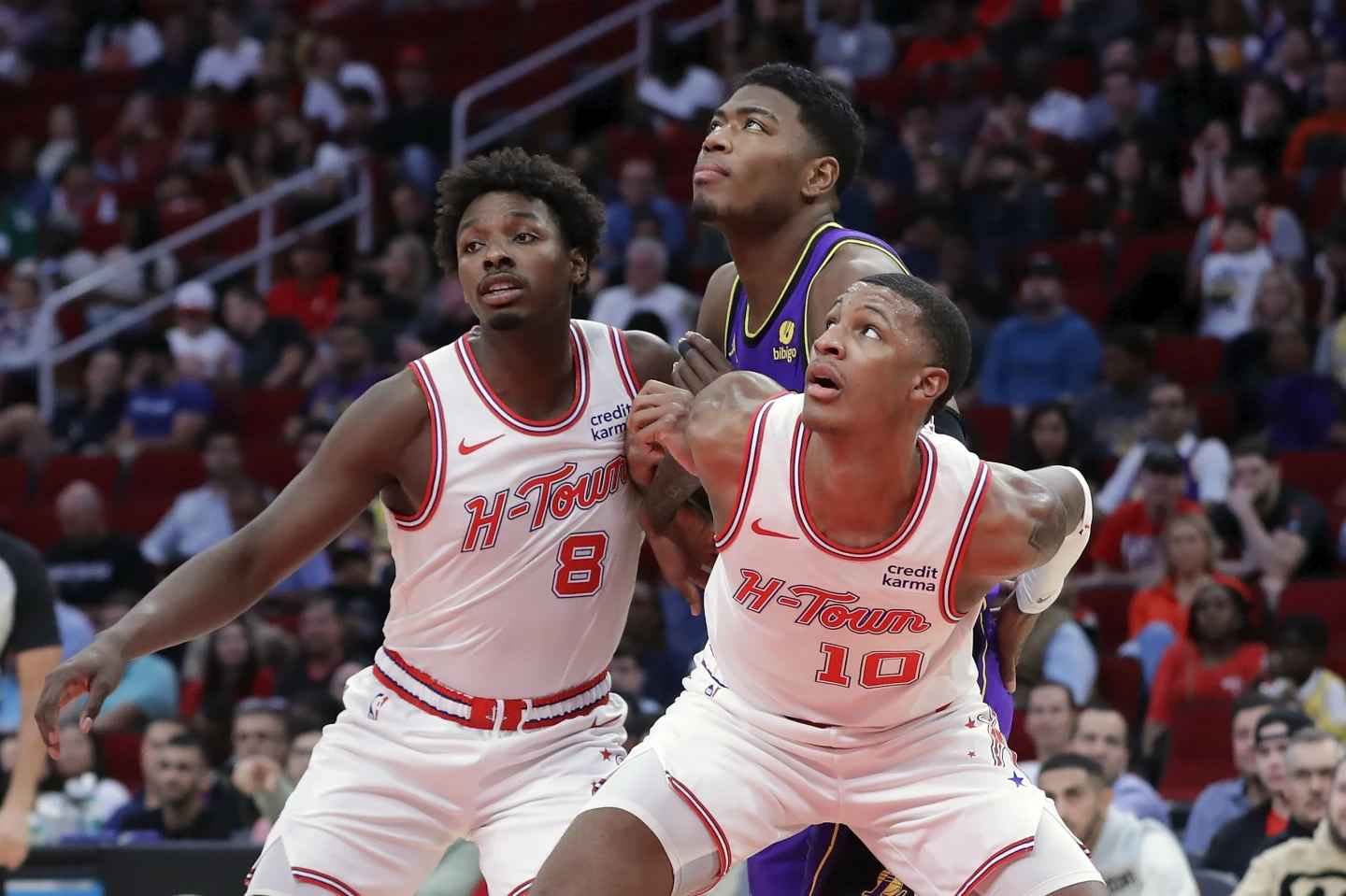 During the first half of an NBA basketball game Wednesday, Nov. 8, 2023, in Houston, Los Angeles Lakers player Rui Hachimura, center, is blocked out on a free throw by Houston Rockets forwards Jae'Sean Tate (8) and Jabar Smith Jr. (10). (Photo by Michael Wyke)